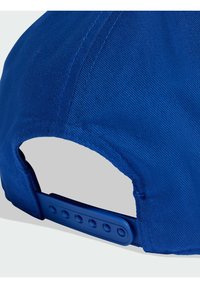 Blue baseball cap with a textured fabric, curved brim, adjustable plastic strap at the back featuring multiple holes for size adjustment.