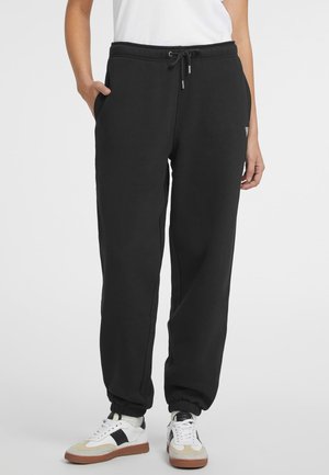 Pantaloni della tuta neri con una vita regolabile, tasche laterali e polsini a costine. Realizzati in tessuto morbido, presentano un piccolo logo sul lato.