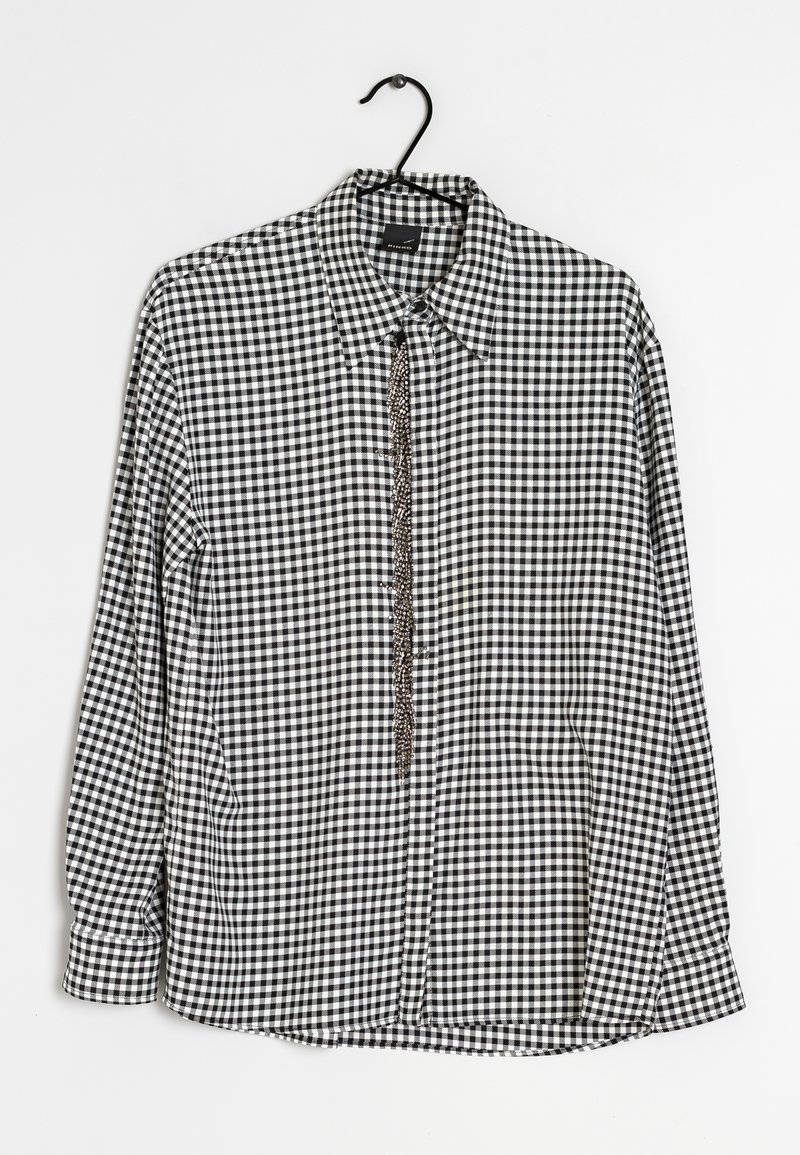 Svart- och vitrutigt långärmat skjorta med krage och knappstängning fram. Har en kedjeaccent längs knappslån.