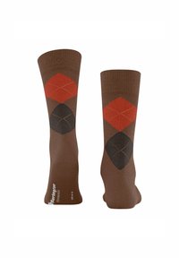 Calzini marroni con motivo a rombi arancioni e neri, con accenti di cucitura chiara. Misura 40-46. Design a maglia testurizzata.