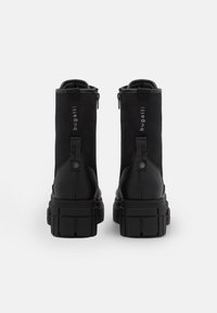 Pair of black high-top boots with chunky soles, rear zipper, and "bugatti" logo on heel pull tabs against a plain white background.