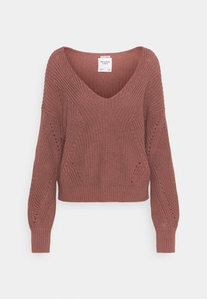 Rust-colored knitted sweater with V-neck, long sleeves, textured pattern, and ribbed cuffs and hem.