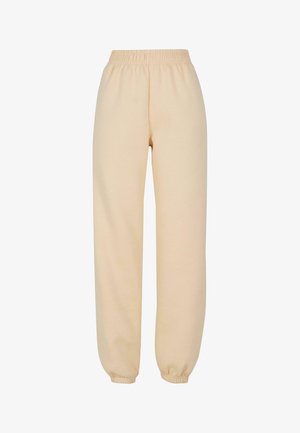 Gaiši bēžīgas sporta bikses, izgatavotas no mīksta un strukturēta auduma. Tām ir elastīga josta un pieguļoši aproces pie potītēm, nodrošinot brīvu piegulumu.