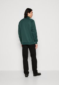 adidas Originals FIRST - Träningsjacka - mineral green