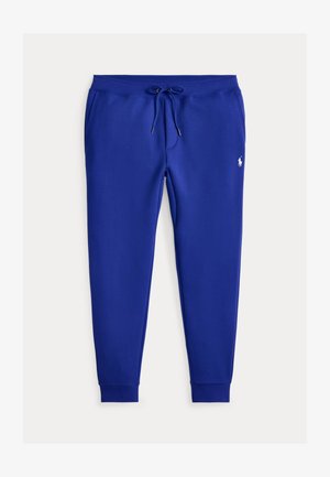 Pantalon de jogging bleu avec taille à cordon, poches latérales, chevilles resserrées et petit logo blanc brodé sur la partie supérieure de la cuisse gauche.