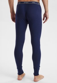 Navy thermal leggings with a fitted design, elastic waistband featuring the "JBS" logo, and ribbed cuffs at the ankles. Smooth texture.
