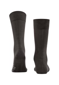 Schwarze Baumwollsocken mit geripptem Bündchen, nahtlosem Zehenbereich und verstärkter Ferse. Auffälliges Muster auf der Sohle und ein Markenlabel in der Nähe des Knöchels.