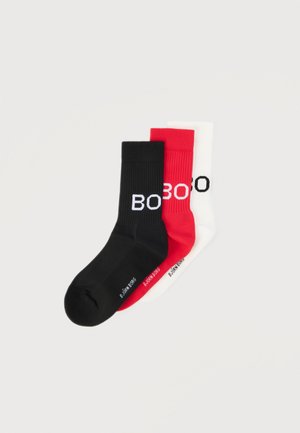 Three pairs of ribbed crew socks in black, red, and white with partial "BO" lettering and small brand text near toes, arranged overlapping.
