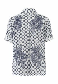 Camicia maniche corte con colletto in bianco  con pois blu navy e ricami floreali. Presenta un orlo scallop e dettagli in tessuto testurizzato.