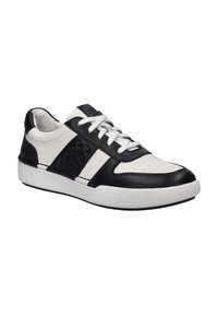 Black and white athletic sneakers featuring leather materials, perforated toe box, and textured white rubber sole. Accented with stitched detailing.