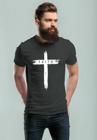 Black cotton t-shirt featuring a white brushstroke cross design with the word "FAITH" printed horizontally across the center.