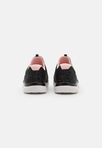 Black slip-on shoes with a leopard print design, featuring a pink interior and white rubber sole. Sleek, rounded shape with a textured finish.