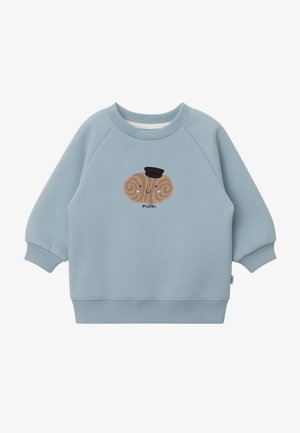 Light blue sweatshirt featuring a cartoon design of a brown creature with spiral accents and a black hat, soft texture, and ribbed cuffs.
