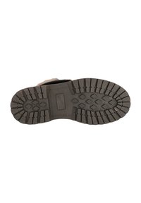 Svart gummisula med texturerat mönster för grepp, med ett hexagonalt mönster och djupa räfflor för bra fäste och hållbarhet.