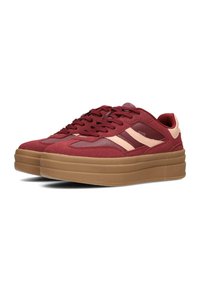 Rote Wildleder-Plateausneaker mit beigen Akzenten, runder Zehenform, dickem Gummisohle und Schnürverschluss.