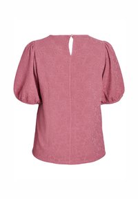 Blouse rose texturée avec des manches bouffantes, détail en forme de clé dans le dos, motif floral et coupe décontractée. Idéale pour une tenue décontractée.