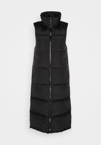 Svart ärmlös pufferväst med hög krage och framzipper. Har vadderade sektioner och två sidofickor. Slät tygtextur.