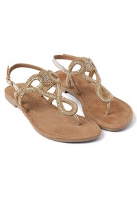 Sandali piatti con una soletta in suede color nocciola e decorazioni in perline dorate. Il design open-toe presenta una fascia a T con un motivo ad anello.