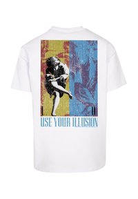 White t-shirt featuring a multicolored graphic on the back. Design includes a sketched figure on a yellow and blue background with the text "USE YOUR ILLUSION."