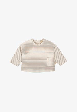 Top a rayas en color crema, con mangas tres cuartos, cuello redondo y un bolsillo frontal. Está hecho de una tela suave, con rayas de color beige claro uniformemente distribuidas.