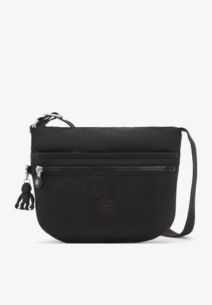 Borsa a tracolla nera in nylon con una tasca frontale con zip, forma arrotondata, tracolla in tessuto e un piccolo portachiavi a forma di scimmia.