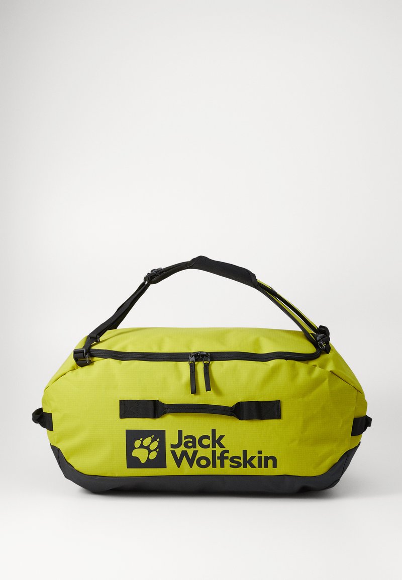 Gele sporttas met zwarte accenten, gewatteerde handgrepen en twee ritscompartimenten. Bevat het Jack Wolfskin-logo dat prominent is weergegeven.