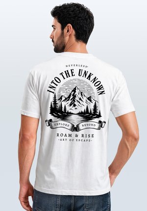 Man wearing white t-shirt with black graphic of mountains, trees, and text "Into the Unknown, Explore Beyond, Roam & Rise, Art of Escape" on back.