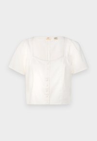 Blusa bianca corta con maniche a sbuffo, scollatura quadrata e chiusura frontale con bottoni. Realizzata in tessuto liscio con una leggera trama.