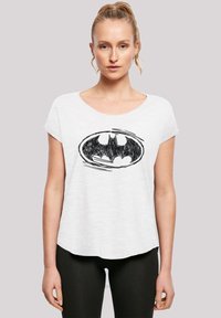 Valkoinen lyhythihainen t-paita, jossa on musta Batman-logo keskell�ä. Pehmeä, kevyt kangas ja rento istuvuus.