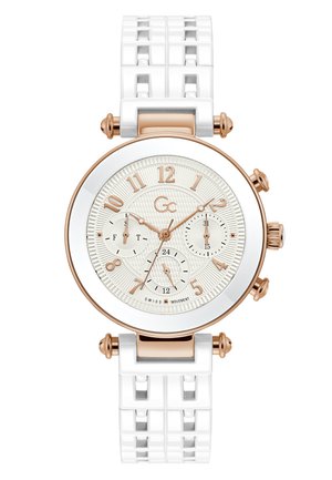 White silicone watch with a textured cream dial, rose gold accents, large numeral markers, and three sub-dials. Features a patterned strap.