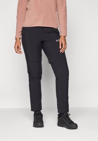 Schwarze Sporthose mit schmaler Passform, aus leichtem, dehnbarem Material. Mit Logo auf dem linken Oberschenkel, flachen Nähten und Taschen.