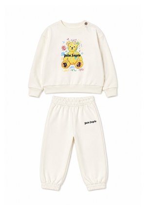 Crèmekleurige kinderset met kleurrijke teddybeerprint op de trui en tekst "Palm Angels" op de broek en het shirt.