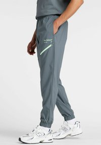 REIMAGINED - Tracksuit bottoms - graphite