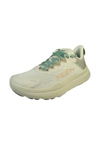 Sneaker leggera con una tomaia in rete beige, lacci turchesi e una suola ammortizzata. Presenta una linguetta e dettagli perforati.