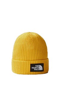 Yellow knitted beanie hat with a ribbed texture, featuring a black label with white text and logo at the front. No embellishments visible.