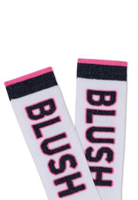 Witte sokken met opvallende "BLUSH" letters in het zwart met roze omlijning; afgewerkt met een marineblauwe glanzende band en roze rand.