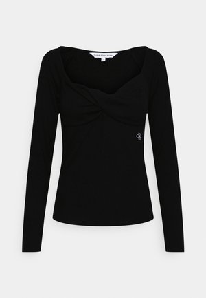 Zwart top met lange mouwen met een gedraaide voorkant, gemaakt van geribd materiaal, met een subtiel geborduurd logo aan de zijkant.