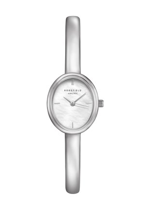 Reloj de pulsera plateado y delgado con esfera oval blanca, marcadores de hora mínimos y tres agujas que muestran las 10:09:19, nombre de la marca Rosefield en la esfera.