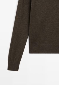 Brown knitted sweater featuring a crew neck, long sleeves, and ribbed cuffs and hem. Soft texture with a smooth finish.