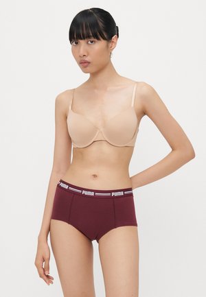 Beženi bralette sa podesivim trakama, uparen s bordo visokim gaćicama koje imaju elastičan pojas s brandom. Glatka tekstura.