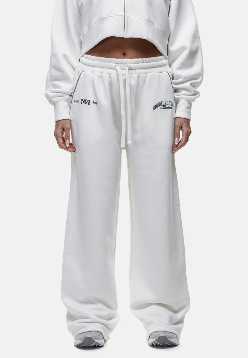 Witte katoenen joggers met een relaxte pasvorm, elastische tailleband, koord en bedrukkingen op de linkerdij en het rechterzakgebied.