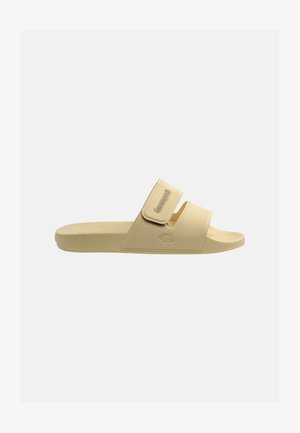 Sandalo beige con punta singola, plantare testurizzato, cinturino regolabile con chiusura in Velcro e piccolo logo in rilievo sul cinturino e sul lato.