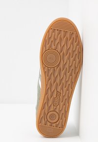 Shoe sole with brown rubber tread, Gabor logo, size 4½ marking, and "Made in Slovakia" text on a white background.