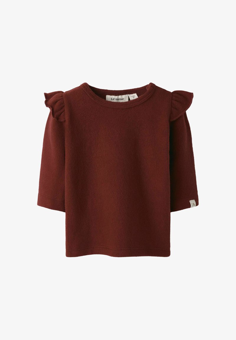 Burgunderfärgad fleece-tröja med korta ärmar och volangdetaljer vid axlarna. Rundad halsringning och en liten märkesetikett på sidan. Mjuk textur.