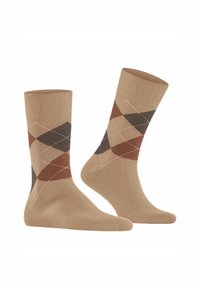 Beige Socken mit einem Argyle-Muster, das braune, dunkelgrüne und hellbraune Rauten enthält, akzentuiert durch weiße Rautenlinien.