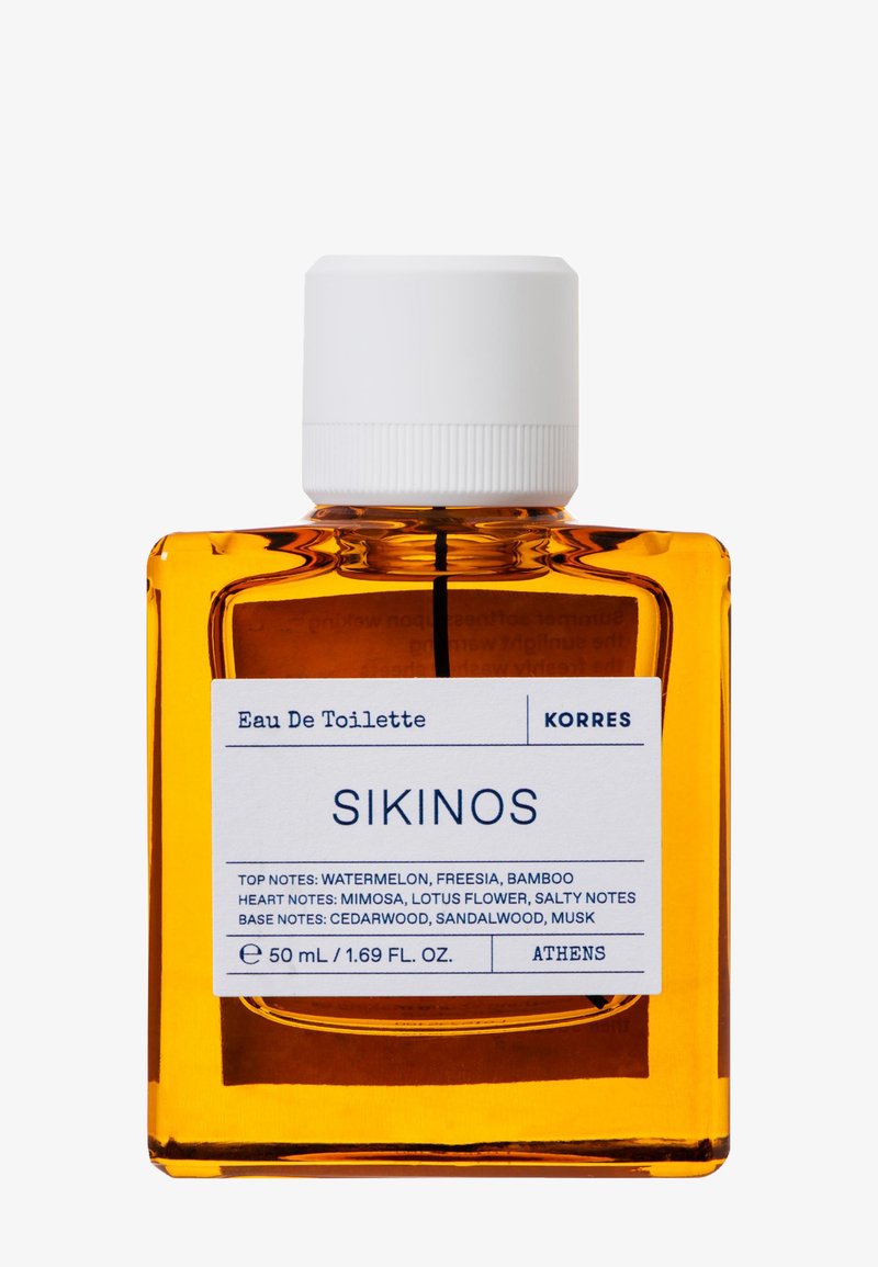 Klar glasflaska fylld med bärnstensfärgad vätska, vit skruvkork, märkt "SIKINOS" med doftnoter, mäter 50 mL/1.69 FL OZ.