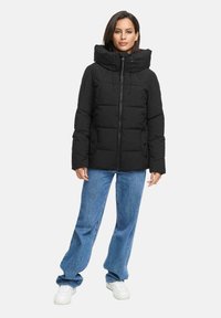 Black puffer jacket with a high collar, front zipper, and adjustable drawstrings. Features quilted design and two side pockets.
