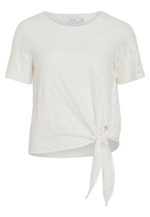 Blouse blanche à manches courtes avec œillets, encolure ronde et détail nœud noué sur le côté devant.