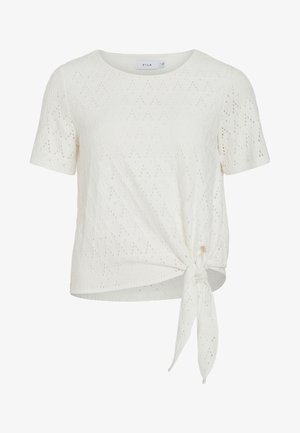 Blouse blanche à manches courtes avec œillets, encolure ronde et détail nœud noué sur le côté devant.