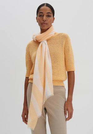 Knit yellow sweater with short sleeves, paired with a light orange and white striped scarf draped around the neck. Smooth texture, casual fit.